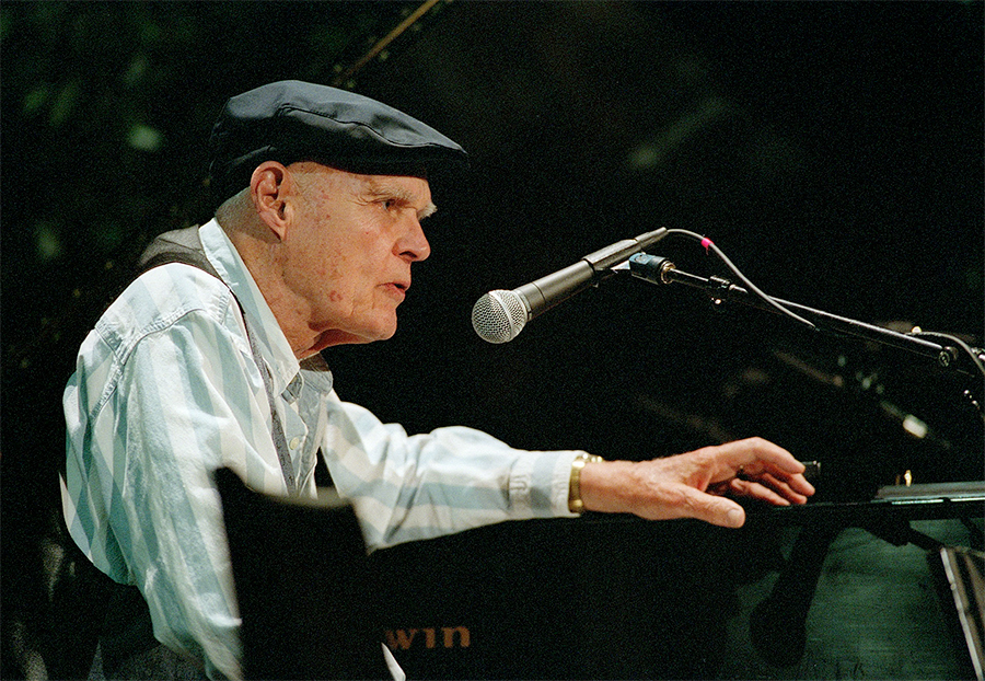 Bob McQuillen at the mic after receiving an award of recognition from the Boston College Irish Studies Program. It was taken during the 2003 Gaelic Roots Festival's Farewell Concert, June 21, 2003 at Robsham Theater, Boston College. The festival was created and directed by Seamus Connolly. Bob was an honored guest at the festival that year.